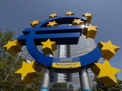A Ukrainian flag reading "Ukraine tomorrow in Europe/EU and in the Euro" is pictured on a big Euro sign in Frankfurt am Main, western Germany, on May 8, 2022, during a pro-Ukrainian protest. (Photo by Yann Schreiber / AFP) (Photo by YANN SCHREIBER/AFP via Getty Images)