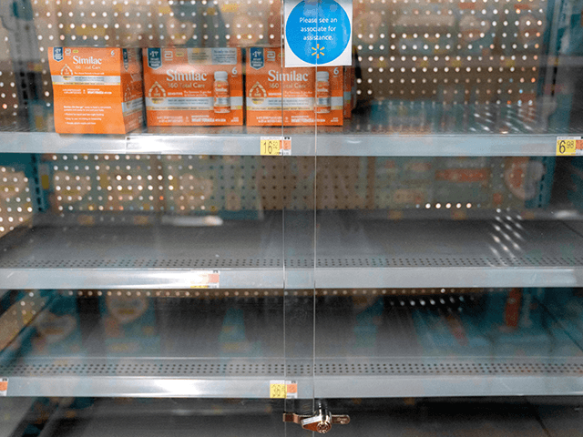 Grocery store shelves where baby formula is typically stocked are locked and nearly empty