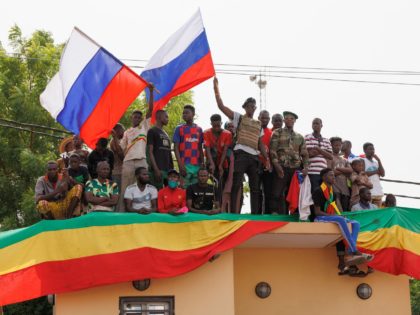 Supporters of Malian Interim President wave flags of Russian during a pro-Junta and pro-Russia rally in Bamako on May 13, 2022. - Several hundred Malians have gathered in Bamako to support the junta, the army and military cooperation with the Russians, AFP journalists report. (Photo by OUSMANE MAKAVELI / AFP) …