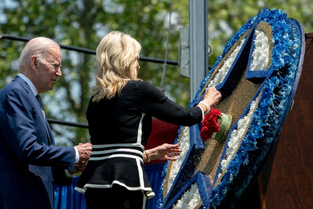 US President Joe Biden, joined by US First Lady Jill Biden, places a flower on a wreath during the National Peace Officers Memorial Service at the US Capitol in Washington, DC, on May 15, 2022. (Photo by Stefani Reynolds / AFP) (Photo by STEFANI REYNOLDS/AFP via Getty Images)