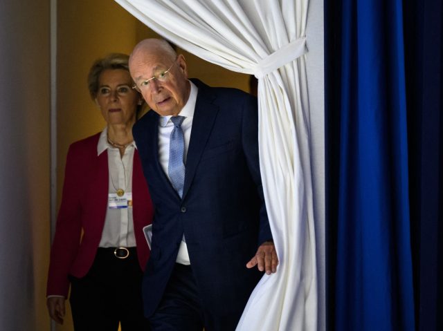 European Commission President Ursula von der Leyen (L) and Founder and executive chairman of the World Economic Forum Klaus Schwab enter the stage prior to address the assembly at the World Economic Forum (WEF) annual meeting in Davos on May 24, 2022. (Photo by Fabrice COFFRINI / AFP) (Photo by …