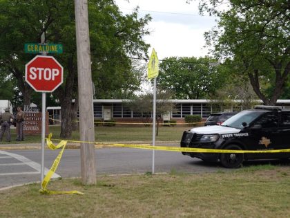 Sheriff crime scene tape is seen outside of Robb Elementary School as State troopers guard