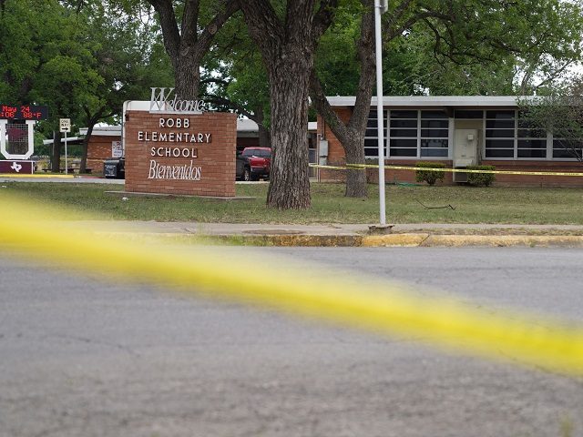 Sheriff crime scene tape is seen outside of Robb Elementary School as State troopers guard the area in Uvalde, Texas, on May 24, 2022. - An 18-year-old gunman killed 14 children and a teacher at an elementary school in Texas on Tuesday, according to the state's governor, in the nation's …