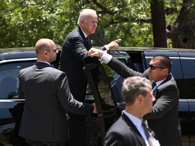 US President Joe Biden gestures at people gathered outside after attending Mass at Sacred
