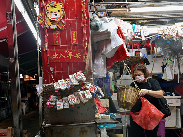 A market trader packs up her shop at the end of the business day in Hong Kong on May 31, 2022. (Photo by Peter PARKS / AFP) (Photo by PETER PARKS/AFP via Getty Images)