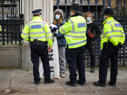 LONDON, ENGLAND - FEBRUARY 10: Protestors demonstrating against student fees are stopped outside the Houses of Parliament by the police due to the current lockdown restrictions preventing public gatherings, on February 10, 2021 in London, England. With a surge of COVID-19 cases fueled partly by a more infectious variant of …