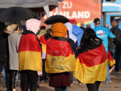 HALDENSLEBEN, GERMANY - MAY 28: Teenage girls draped in German flags attend an election campaign rally of the right-wing Alternative for Germany (AfD) ahead of upcoming state elections in Saxony-Anhalt on May 28, 2021 in Haldensleben, Germany. Saxony-Anhalt is due to hold state elections on June 6. The AfD is …