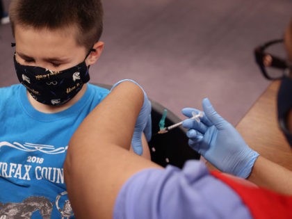 ANNANDALE, VIRGINIA - NOVEMBER 04: A child receives the Pfizer BioNTech COVID-19 vaccination at the Fairfax County Government Center on November 04, 2021 in Annandale, Virginia. The federal government approved the coronavirus vaccine for children between the ages of 5 and 11 this week. (Photo by Chip Somodevilla/Getty Images)