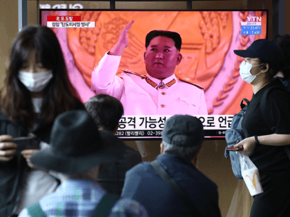 People watch a television broadcast showing a file image of North Korean leader Kim Jong-Un during a military parade at the Seoul Railway Station on May 04, 2022 in Seoul, South Korea. An unidentified projectile was fired by North Korea towards the East Sea according to reports from South Korea's …