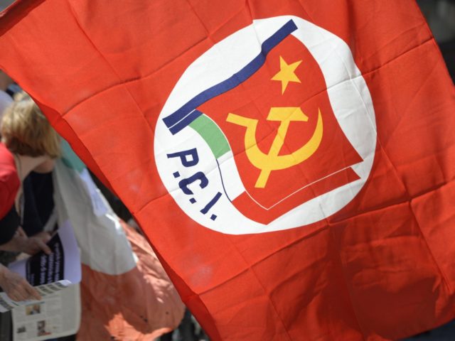 A protester holds an Italian communist party flag during a demonstartion in front of the p