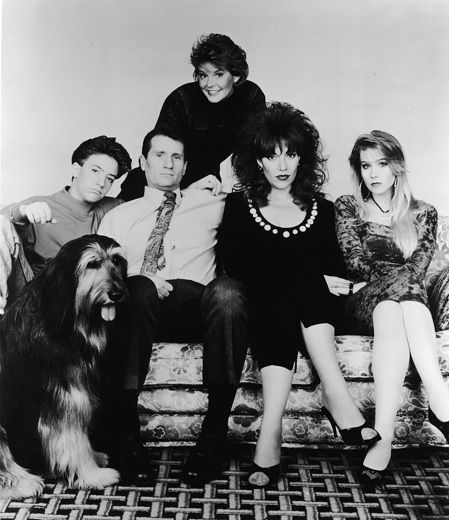 A promotional portrait of the cast of the television series 'Married With Children,' 1990. (L-R) David Faustino, Ed o'Neill, Katey Segal, Christina Applegate, and Amanda Bearse (standing at back). (Photo by Columbia Pictures/Courtesy of Getty Images)