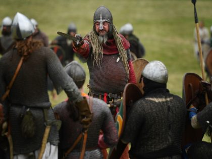 Re-enactors prepare to take part in the re-enactment of the Battle of Hastings, at Battle Abbey in Battle, southern England, on October 14, 2016. 2,000 re-enactors dressed in period costume will mark the 950th anniversary of the Battle of Hastings. The battle, on October 14, 1066, between William of Normandy …