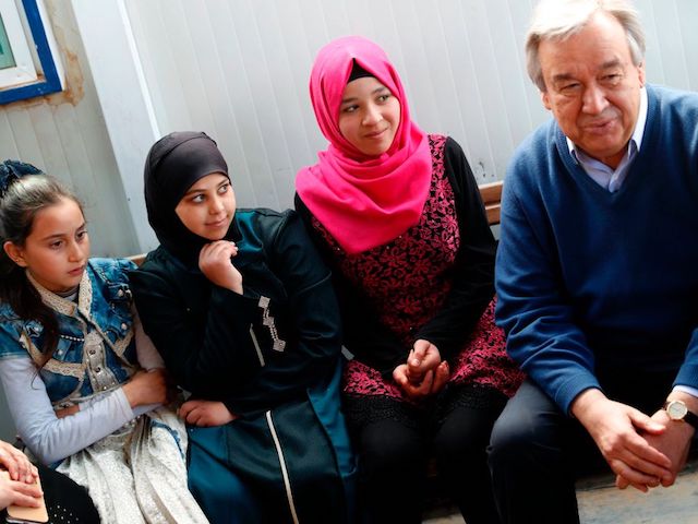 United Nations Secretary General Antonio Guterres (R) talks to Syrian women and girls during a visit to the Zaatari refugee camp which shelters some 80,000 Syrian refugees on the Jordanian border with war-ravaged Syria on March 28, 2017. Syria's devastating civil war, now in its seventh year, has rendered more than half the country's population refugees. The conflict has left more than 320,000 people dead, according to the Syrian Observatory for Human Rights. / AFP PHOTO / THOMAS COEX (Photo credit should read THOMAS COEX/AFP via Getty Images)