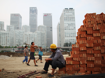 A workers on a construction site for a city park which will be completed before National Day near the center business district on September 2, 2009 in Beijing, China. Local authorities are renovating and decorating Beijing in preparation for the upcoming National Day on October 1, 2009 which this year …