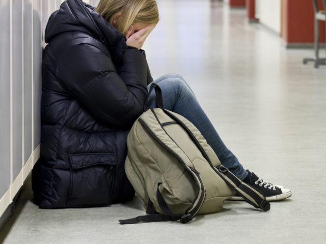 Young woman crying at school