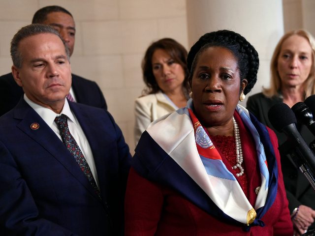 Rep. Sheila Jackson Lee, D-Texas, second from right, speaks to reporters during a break in