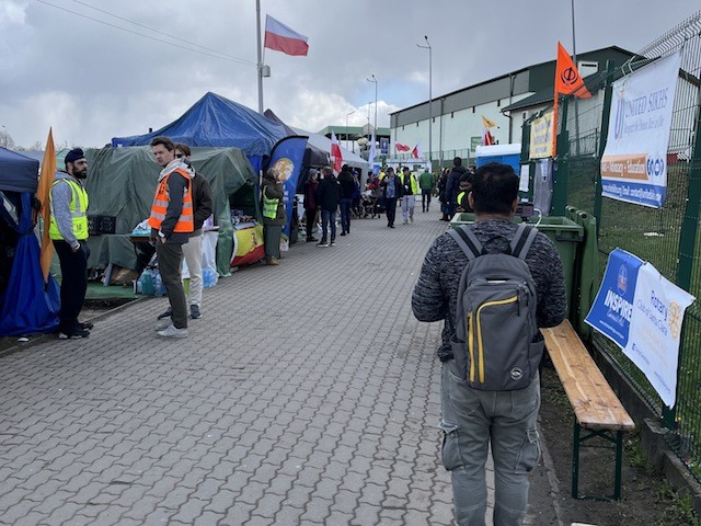 Walkway to the Ukrainian border from Poland lined with tents of volunteers providing food, water, coffee. (Courtesy James G. Zumwalt)