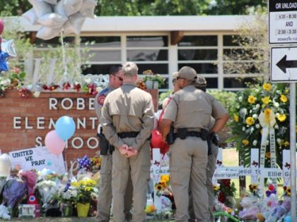 Texas DPS troopers stand watch outside a memorial at Robb Elementary School in Uvalde. (Ra