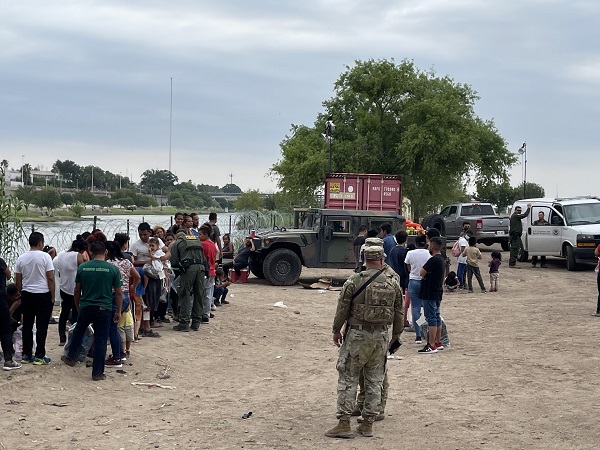 Border Patrol agents and Texas National Guardsmen process another large group of migrants near the international bridge to Mexico. (Randy Clark/Breitbart Texas)