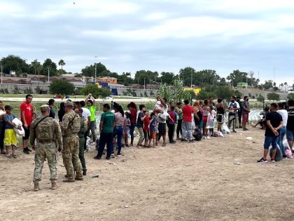Eagle Pass Border Patrol agents and Texas National Guard soldiers detain a group of migrants who illegally crossed the border into Eagle Pass, Texas. (Randy Clark/Breitbart Texas)