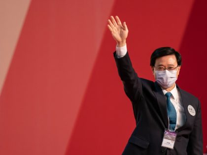HONG KONG, CHINA - MAY 08: Hong Kong Chief Executive-elect John Lee Ka-chiu waves on stage after being elected at the Exhibition and Convention Centre on May 08, 2022 in Hong Kong, China. Lee, a 64-year- old former police officer, Chief Secretary and sole candidate in the election for city's …