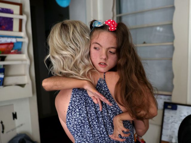 SANTA ROSA, CALIFORNIA - MAY 18: Keely Aguilar carries her 11-year-old daughter Natalyah Aguilar to bed on May 18, 2022 in Santa Rosa, California. As a nationwide shortage of baby formula continues, single mother and small business owner Keely Aguilar has been struggling to find formula for her daughter Natalyah …