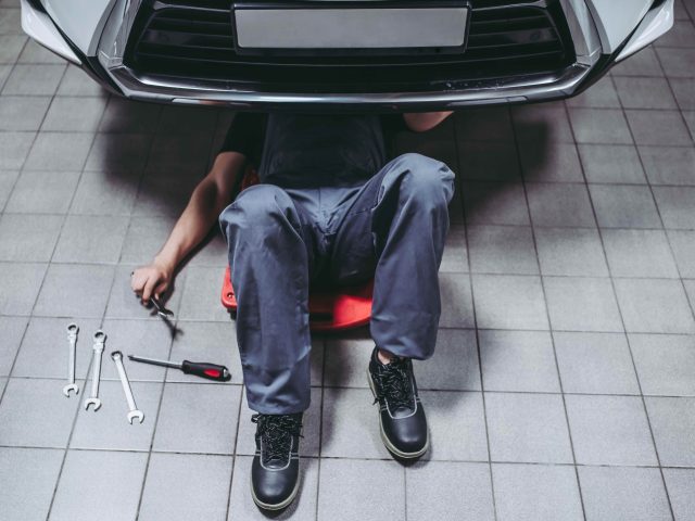 Mechanic under car (Getty)