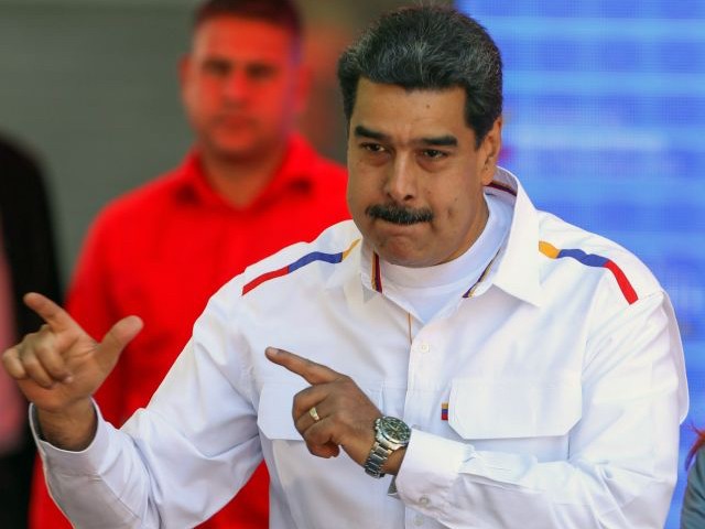 Venezuela's President Nicolas Maduro and his wife Cilia Flores (R) dance during celebrations in the framework of the "Youth Day" at the Bolivar Square in Caracas, Venezuela on February 12, 2019. - Venezuela's opposition leader Juan Guaido told tens of thousands of supporters on Tuesday that desperately-needed humanitarian aid would be brought into the country on February 23, despite opposition from President Nicolas Maduro. (Photo by Orangel HERNANDEZ / AFP) (Photo credit should read ORANGEL HERNANDEZ/AFP via Getty Images)