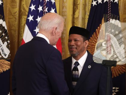U.S. President Joe Biden greets Talib Shareef, Imam of Masjid Muhammad, also known as The Nation’s Mosque, during an Eid al-Fitr reception at the East Room of the White House on May 2, 2022, in Washington, DC. The White House held the event to mark the end of the Muslim …