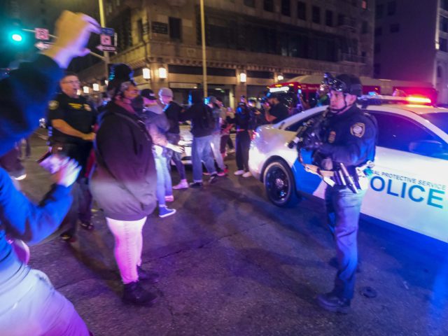 Demonstrators confront police officers near Pershing Square after protesting outside of th