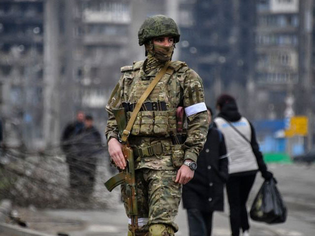 A Russian soldier patrols in a street of Mariupol on April 12, 2022, as Russian troops intensify a campaign to take the strategic port city, part of an anticipated massive onslaught across eastern Ukraine, while Russia's President makes a defiant case for the war on Russia's neighbour. - *EDITOR'S NOTE: …