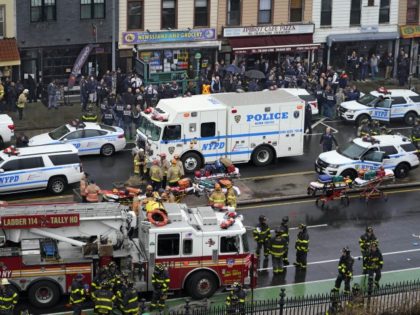 Emergency personnel gather at the entrance to a subway stop in the Brooklyn borough of New York, Tuesday, April 12, 2022. Multiple people were shot and injured Tuesday at a subway station in New York City during a morning rush hour attack that left wounded commuters bleeding on a train …