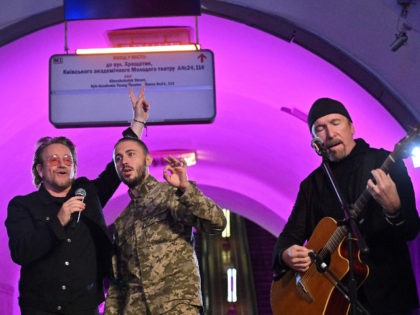 TOPSHOT - Bono (Paul David Hewson), Irish singer-songwriter, activist, and the lead vocalist of the rock band U2, Antytila (C), a Ukrainian musical band leader and now the serviceman in the Ukrainian Army Taras Topolia, and guitarist David Howell Evans aka 'The Edge' perform at subway station which is bomb …