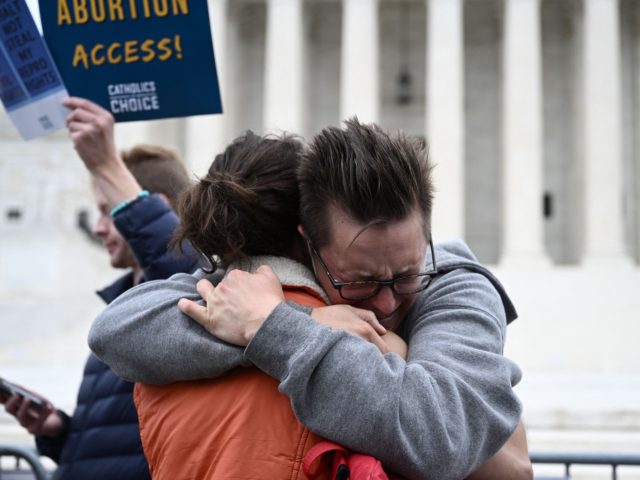 Jessica Golibart embraces a demonstrator in front of the US Supreme Court in Washington, DC, on May 3, 2022. The Supreme Court is poised to strike down the right to abortion in the US, according to a leaked draft of a majority opinion that would shred nearly 50 years of …