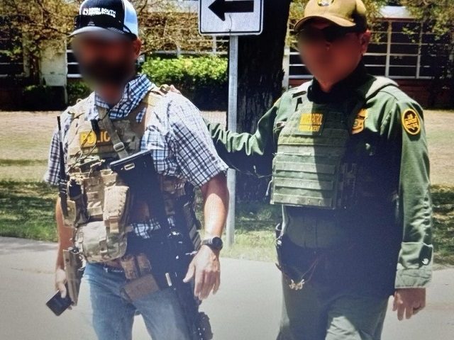 A Border Patrol agent escorts the BORTAC agent from Robb Elementary School after he helped stop the shooter. (CBP Source Photo)