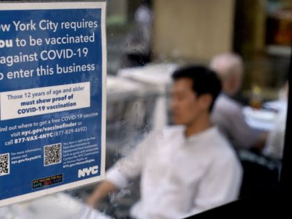 FILE — A notice explaining that proof of vaccination is required to dine inside is seen at a restaurant in midtown Manhattan in New York, Sept. 13, 2021. New York Mayor Eric Adams has said he plans to lift mask requirements in schools and vaccination mandates in restaurants, bars, gyms, …