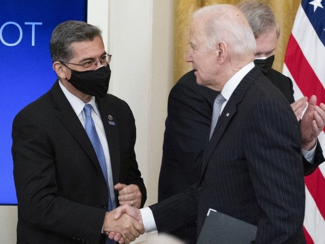 Health and Human Services Secretary Xavier Becerra, left, shakes hands with President Joe Biden after a "Cancer Moonshot" event in the East Room of the White House, Wednesday, Feb. 2, 2022, in Washington. Becerra is head of the United States delegation to the World Health Assembly. (Alex Brandon/AP)