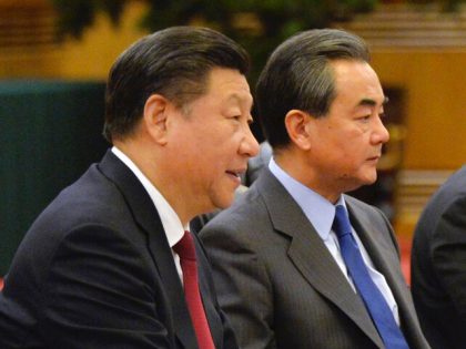 Chinese President Xi Jinpin, left, and Foreign Minister Wang Yi, second from left, attend