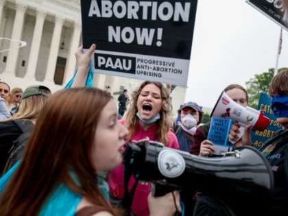 WASHINGTON, DC - MAY 03: Pro-choice and anti-abortion activists demonstrate in front of the U.S. Supreme Court Building on May 03, 2022 in Washington, DC. In a leaked initial draft majority opinion obtained by Politico, Supreme Court Justice Samuel Alito allegedly wrote that the cases Roe v. Wade and Planned …