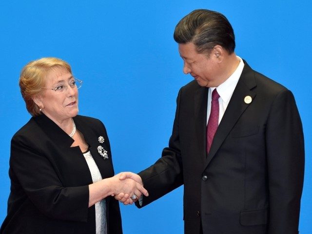 BEIJING, CHINA - MAY 15: Chile's President Michelle Bachelet (L) shakes hands with Chinese President Xi Jinping during the welcome ceremony for the Belt and Road Forum, at the International Conference Center on May 15, 2017 in Yanqi Lake, north of Beijing, China. (Photo by Kenzaburo Fukuhara-Pool/Getty Images)
