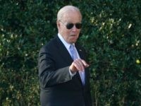 President Joe Biden points out someone in the audience as he arrives for an event to welco