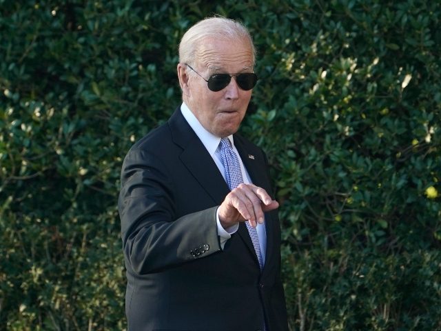 President Joe Biden points out someone in the audience as he arrives for an event to welco