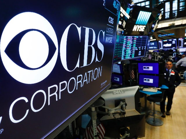 The logo for the CBS Corporation appears above a trading post on the floor of the New York