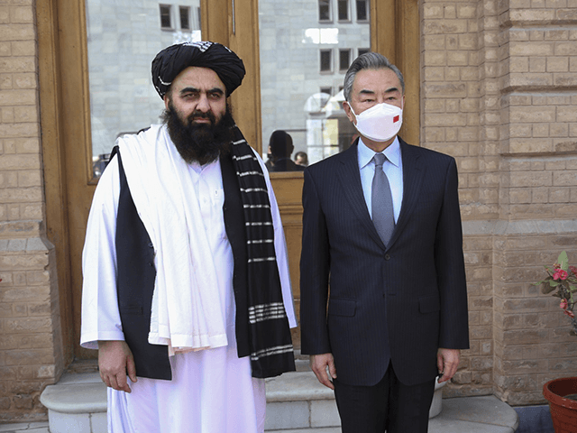 In this photo released by Xinhua News Agency, Chinese Foreign Minister Wang Yi, right, pos