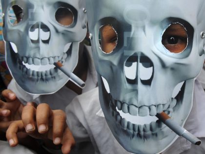 Young schoolchildren wear anti-smoking masks during a 'No Tobacco' rally in Kolkata on May 31, 2012. World No Tobacco Day is observed around the world every year on May 31 and is one of the important World Health Awareness days organized by the World Health Organisation (WHO). AFP PHOTO/Dibyangshu SARKAR …