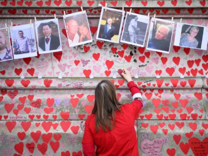 LONDON, ENGLAND - MARCH 29: A woman leaves a message below photos of some of those who die