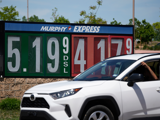 Gasoline prices are displayed outside a convenience store as a motorist drives by, Thursday, May 26, 2022, in Thornton, Colo. Experts are expecting a flush of travelers at airports and on the nation's byways during the long Memorial Day weekend, which marks the start of the summer travel season, in …