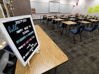 LAS VEGAS, NEVADA - AUGUST 24: A "back to school" message is displayed at the entrance to Kellie Goodall's empty classroom as she teaches an online eighth grade English class at Walter Johnson Junior High School on the first day of distance learning for the Clark County School District amid …