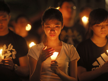 In this June 4, 2015 file photo, people attend a candlelight vigil at Victoria Park in Hong Kong. The group, Hong Kong Alliance in Support of Patriotic Democratic Movements of China, that had organized annual vigils in remembrance of victims of the Chinese military’s crushing of the 1989 Tiananmen Square …