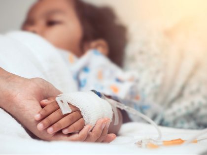 Mother hand holding child hand who have IV solution in the hospital with love and care - stock photo